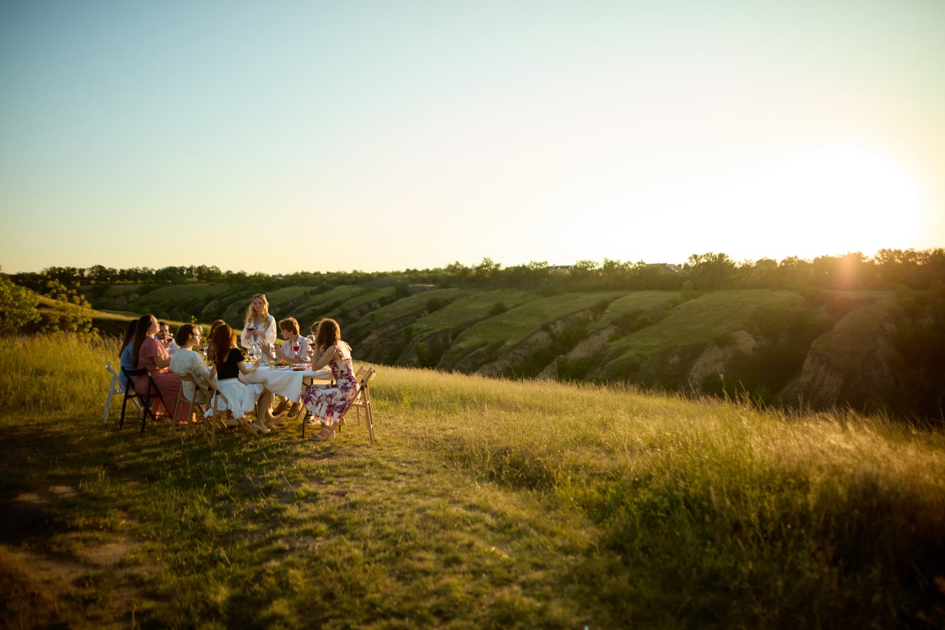 Guests sharing dinner in the Andalusian countryside at sunset