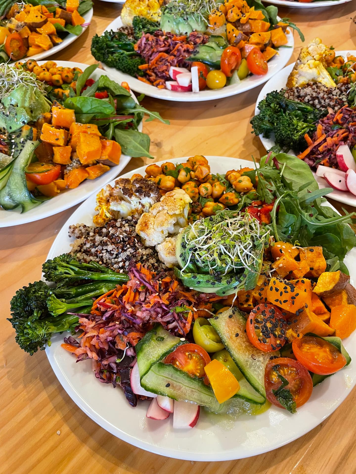 Colourful Buddha bowls with vegetables, quinoa and chickpeas prepared for a retreat